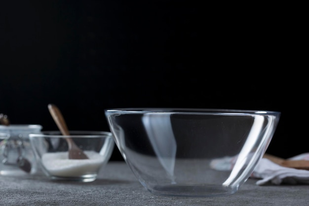 Empty transparent bowl and dishes on the kitchen table Closeup