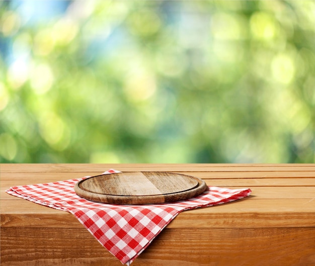 Empty tray on tablecloth on wooden table