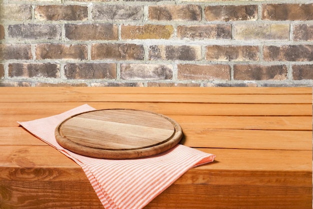 Empty tray on tablecloth on wooden table