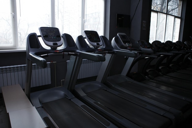 Empty treadmills in a row at the gym