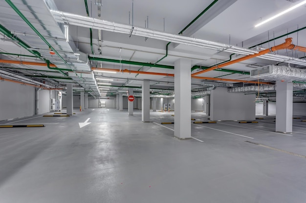 Empty underground garage parking with columns and road markings