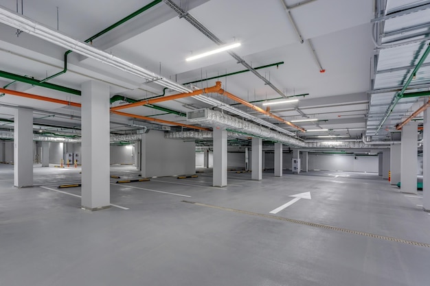 Empty underground garage parking with columns and road markings