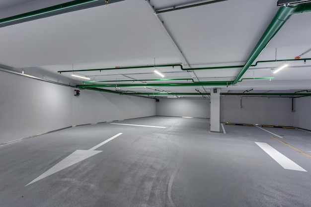 Empty underground garage parking with columns and road markings