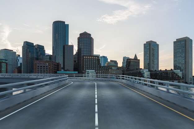 Empty urban asphalt road exterior with city buildings background New modern highway concrete construction Concept of way to success Transportation logistic industry fast delivery Boston USA