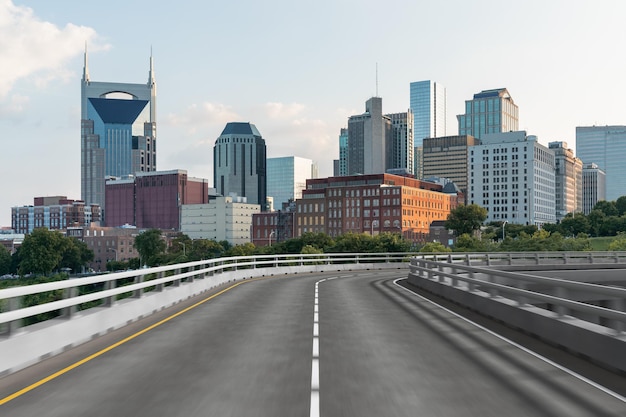 Empty urban asphalt road exterior with city buildings background New modern highway concrete construction Concept of way to success Transportation logistic industry fast delivery Nashville USA