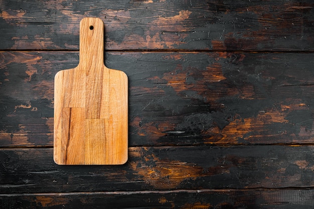 Empty vintage cutting board set, on old dark  wooden table background, top view flat lay , with copy space for text or your product