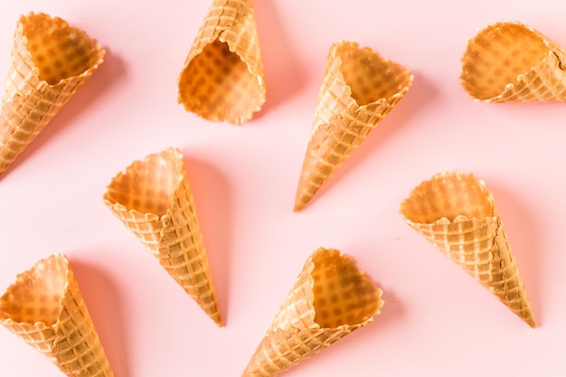 Empty waffle ice cream cones on a pink background