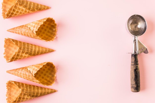 Empty waffle ice cream cones on a pink background.