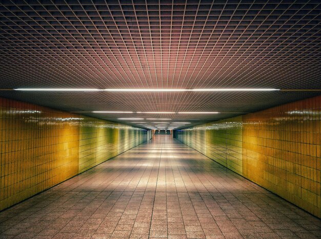 Empty walkway in illuminated corridor