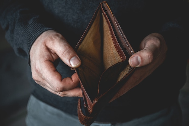 Empty wallet in the hands of a young man