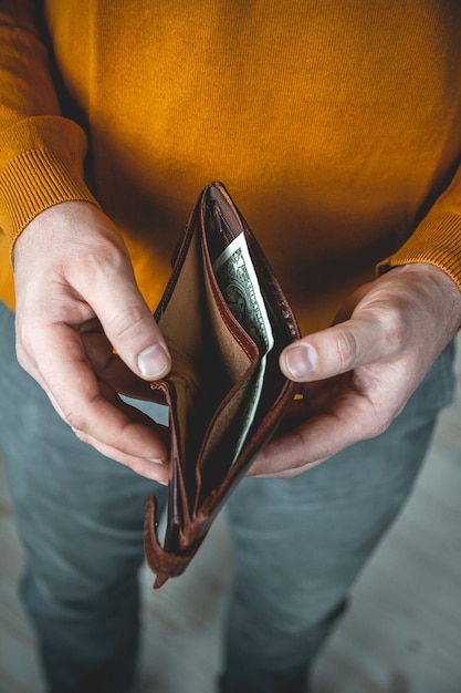 Empty wallet in the hands of a young man