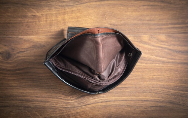 Empty wallet on the wooden table