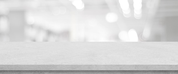 Empty white cement table over blur store background