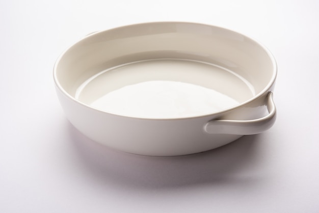 Empty white ceramic serving bowl, isolated over white surface