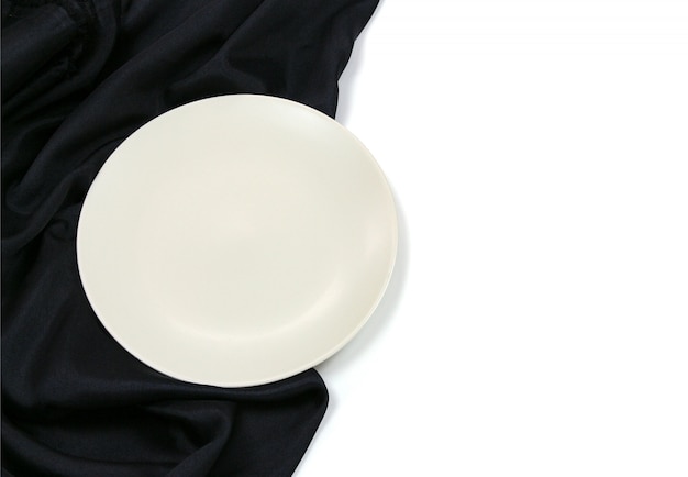 Empty white circle modern ceramic plate with silk tablecloth texture on white background