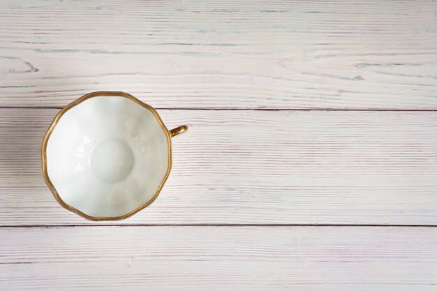 Photo empty white cup on light old wooden background