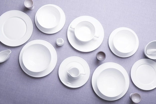 Empty white dishes on grey background