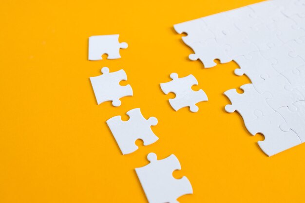 Empty white jigsaw puzzle with missing pieces