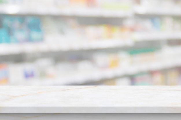 Empty white marble counter top with blur pharmacy drugstore\
shelves background