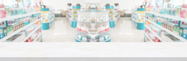 Empty white marble counter top with blur pharmacy drugstore shelves background