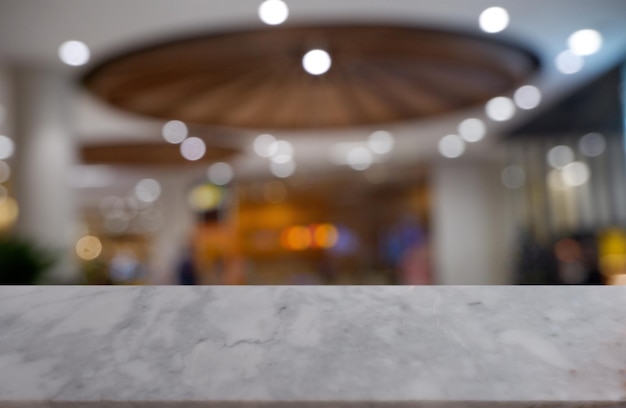 Empty white marble stone table in front of blurred cafe restaurant house for montage product