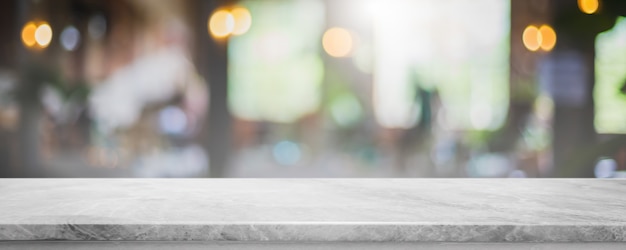 Empty white marble stone table top and blur glass window interior cafe and restaurant banner mock up abstract background - can used for display or montage your products.