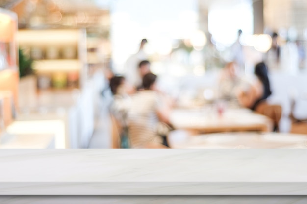 Empty white marble table over blur restaurant background, product and food display montage