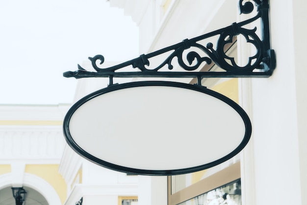 Empty white oval signage on building with classical architecture and daylight Mock up