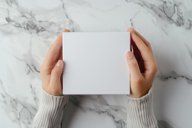 Empty white paper box for cosmetics and accessories held by womans hands