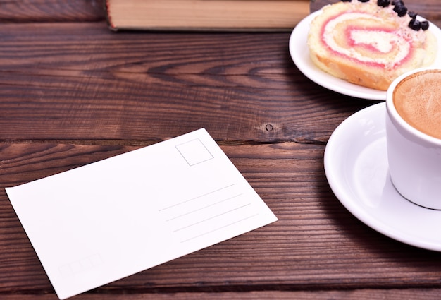 Empty white paper card on the table, side espresso cup