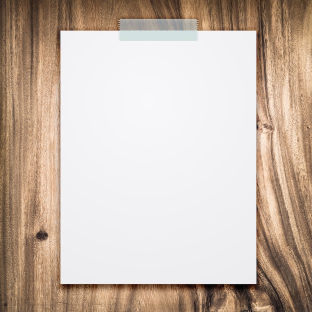 Photo empty white paper sheet on wood background.