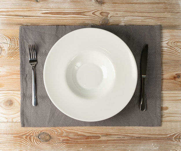 Empty white plate and cutlery mockup