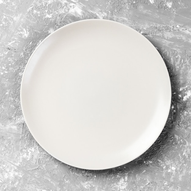 Empty white plate on wood