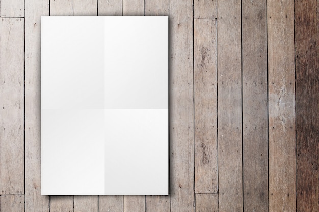 Empty white poster hanging on grunge wood plank wall