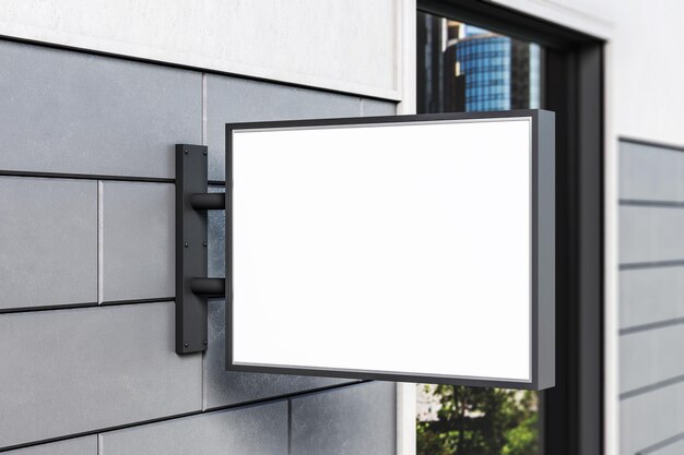 Empty white rectangular billboard on wall