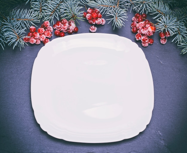 An empty white square plate on black 