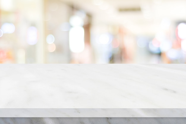 Empty white table top counter desk over blur store