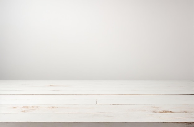 Empty white wooden table over white wall background product display montage