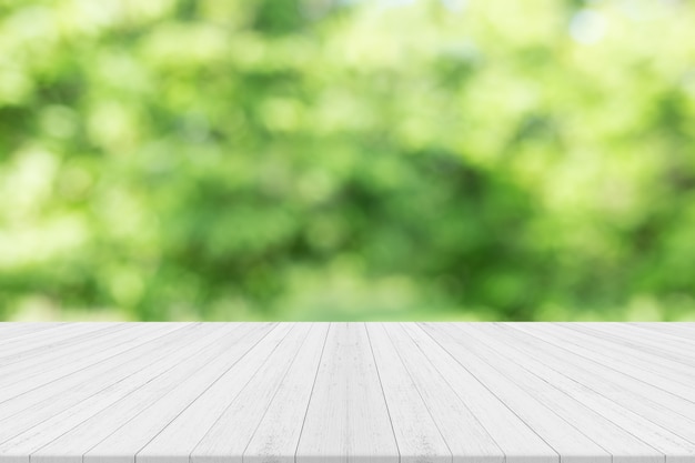 Empty white wooden table with nature green blurred background,Free space for product editing