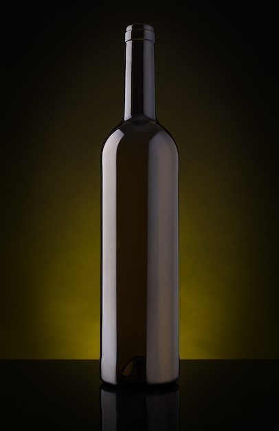 Empty wine bottle without label. On a dark background.