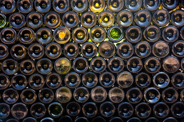 Empty wine bottles stacked-up on one another