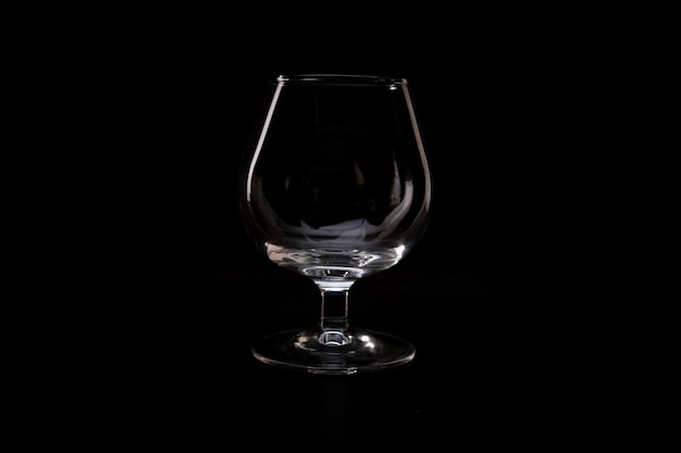 Empty wine glass on a black background