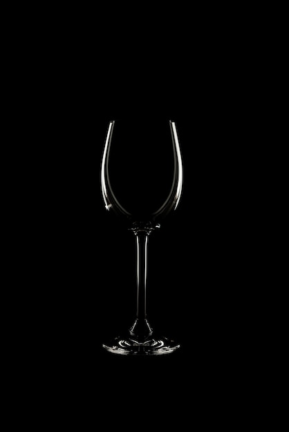 Empty wine glass on black background