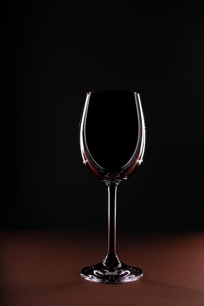 Empty wine glass on black background