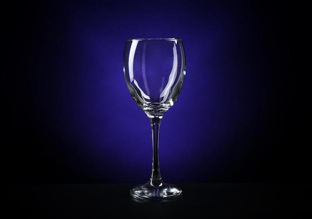 Empty wineglass on dark blue background