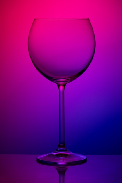 Empty wineglass standing on a colorful background