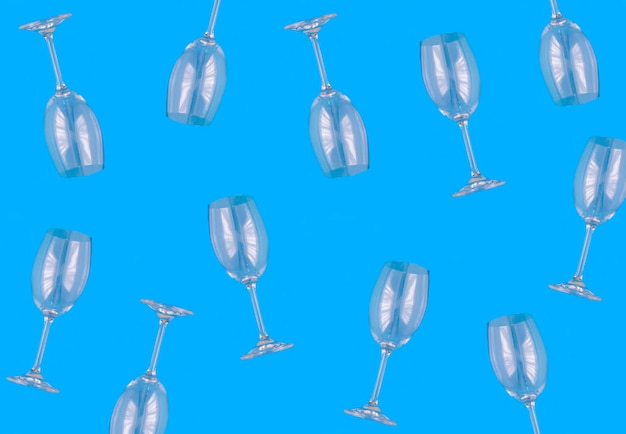 Empty wineglasses on the blue background Top view Pattern Flat lay