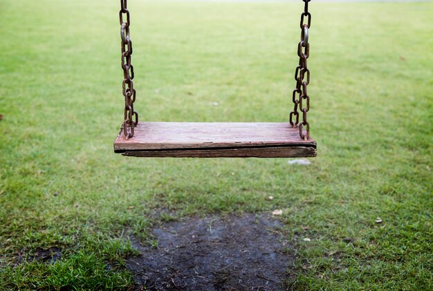 empty wood seat on swing outdoor game