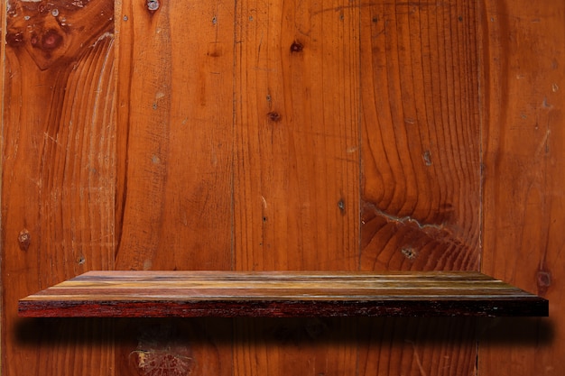 Empty wood shelf on the old wood wall.