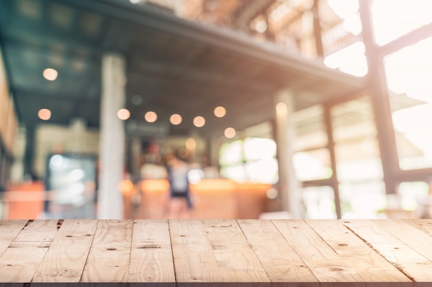 Empty wood table and Blurred background: Customer at coffee shop blur background